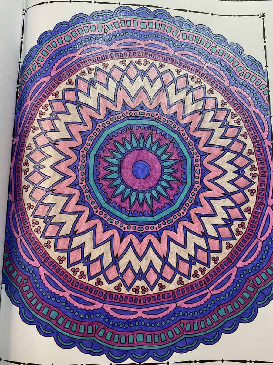 coloring page from many mandalas coloring book colored with glitter gel pens purple and pink